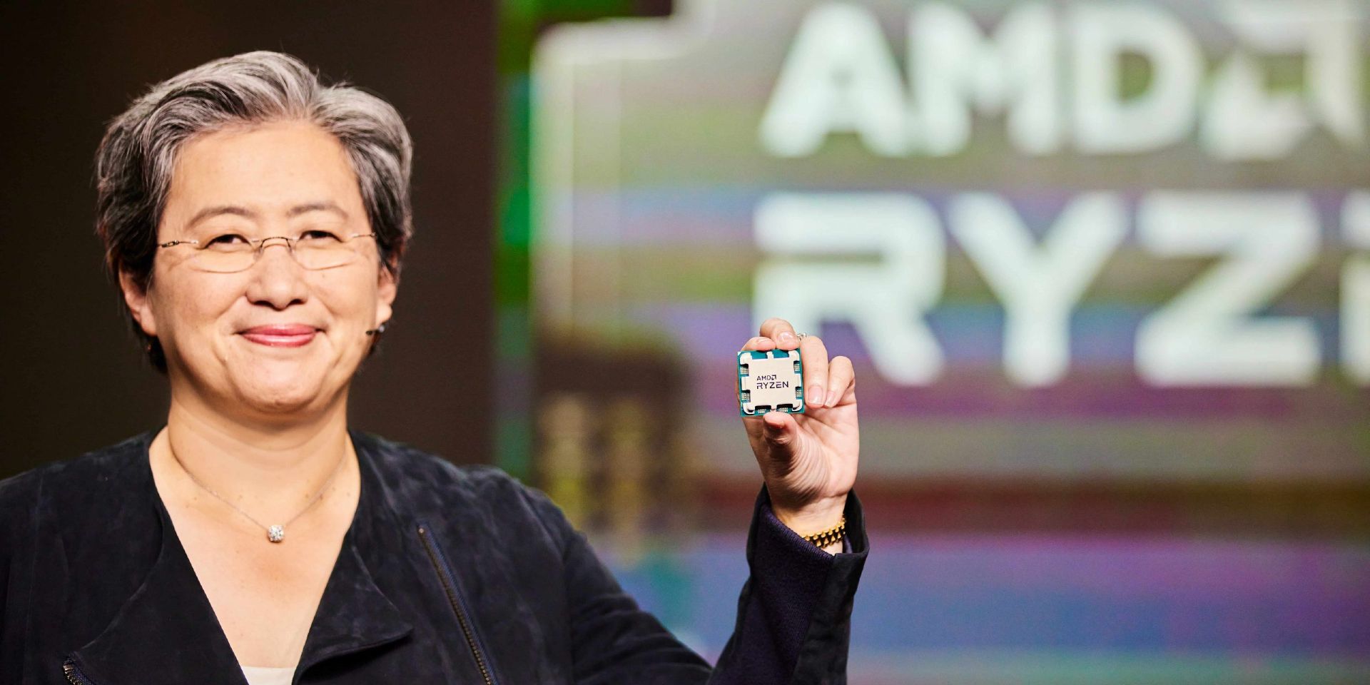 Lisa Su of AMD holding up a Ryzen CPU.