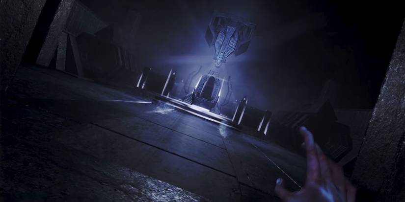 amenesia rebirth player looking at a chair with a ligth behind it 