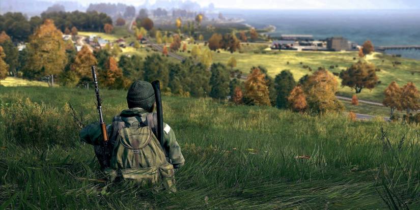 Image from DayZ showing a player sitting down peacefully on a grassy hill.