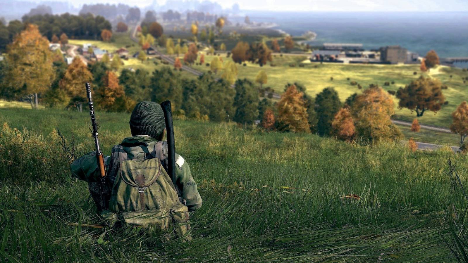 Image from DayZ showing a player sitting down peacefully on a grassy hill.