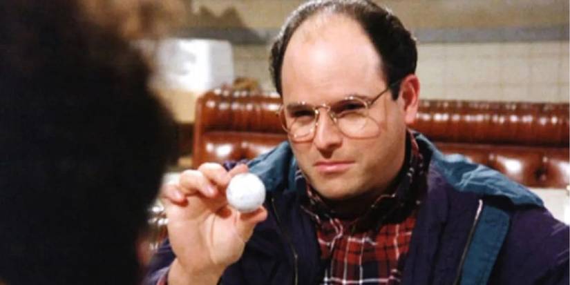 george holding a golf ball