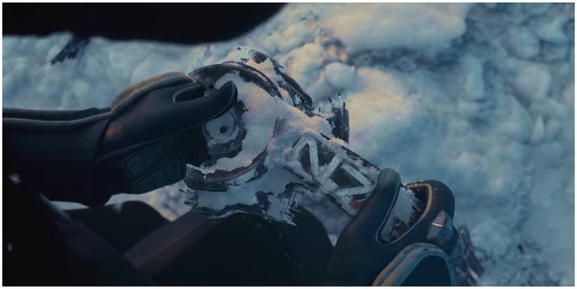 Liara holding Shepard's helmet.