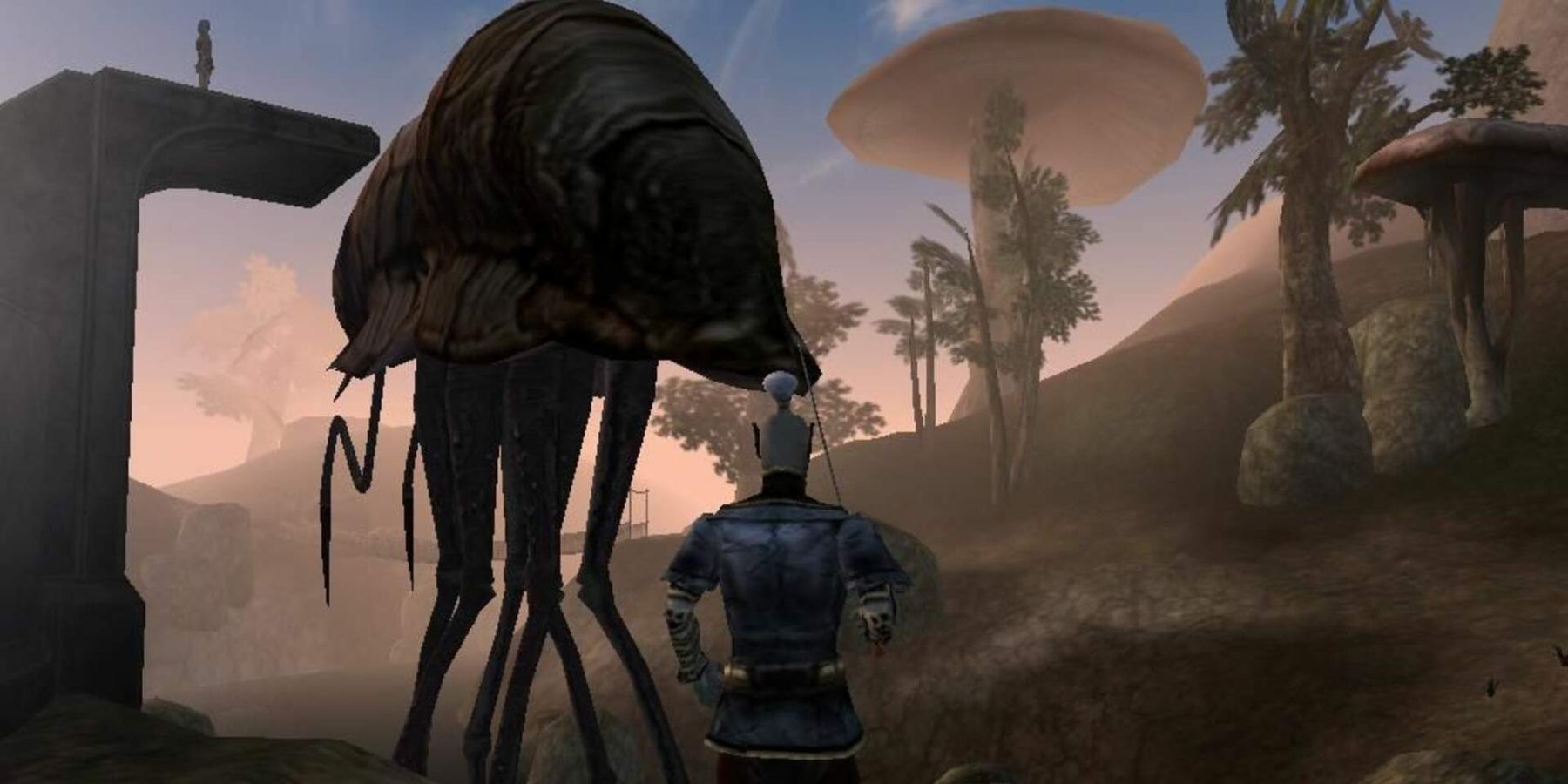 Image from Morrowind showing a Dark Elf stood next to a Silt Strider.