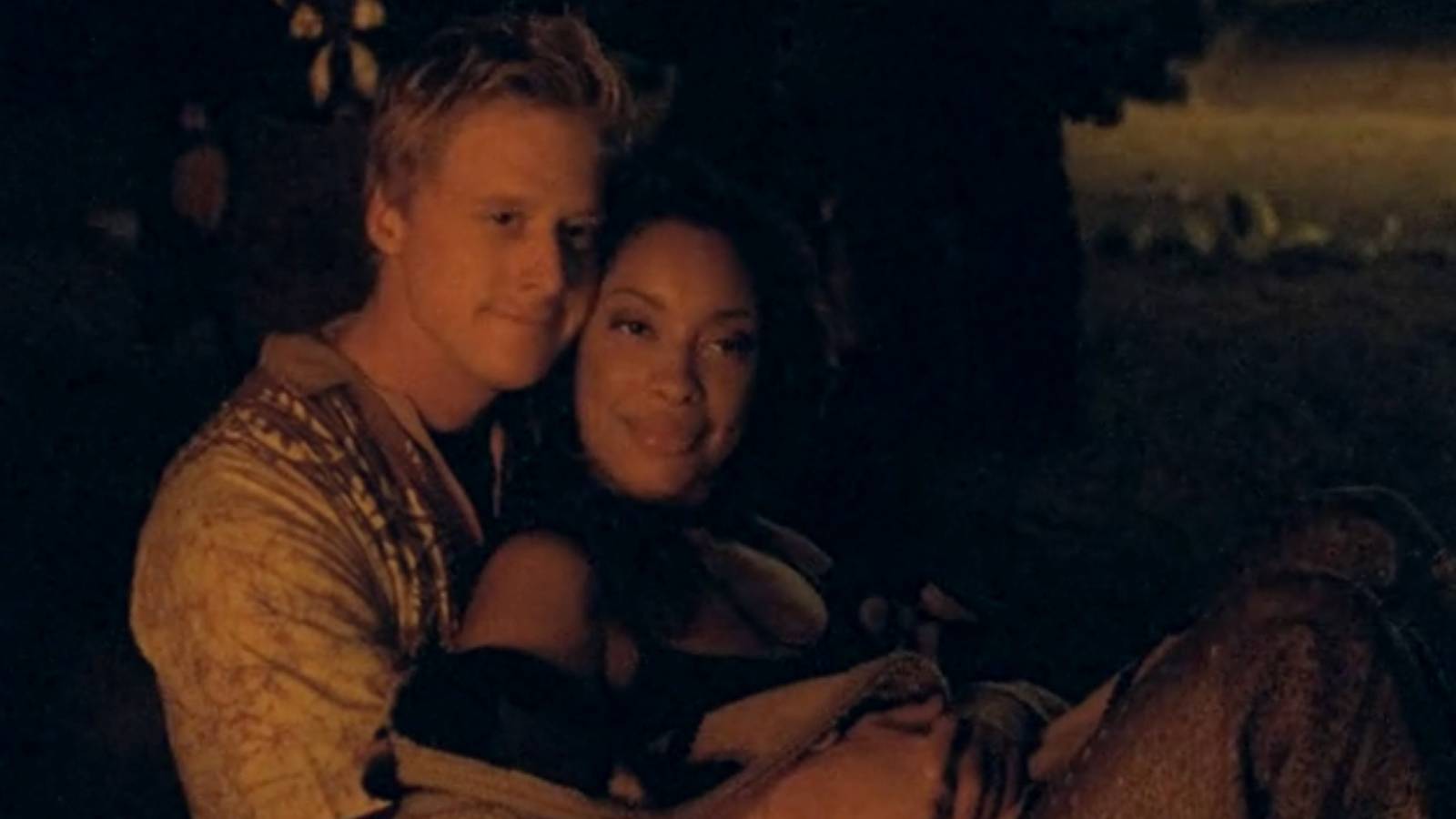 Zoe and wash sitting by a fire