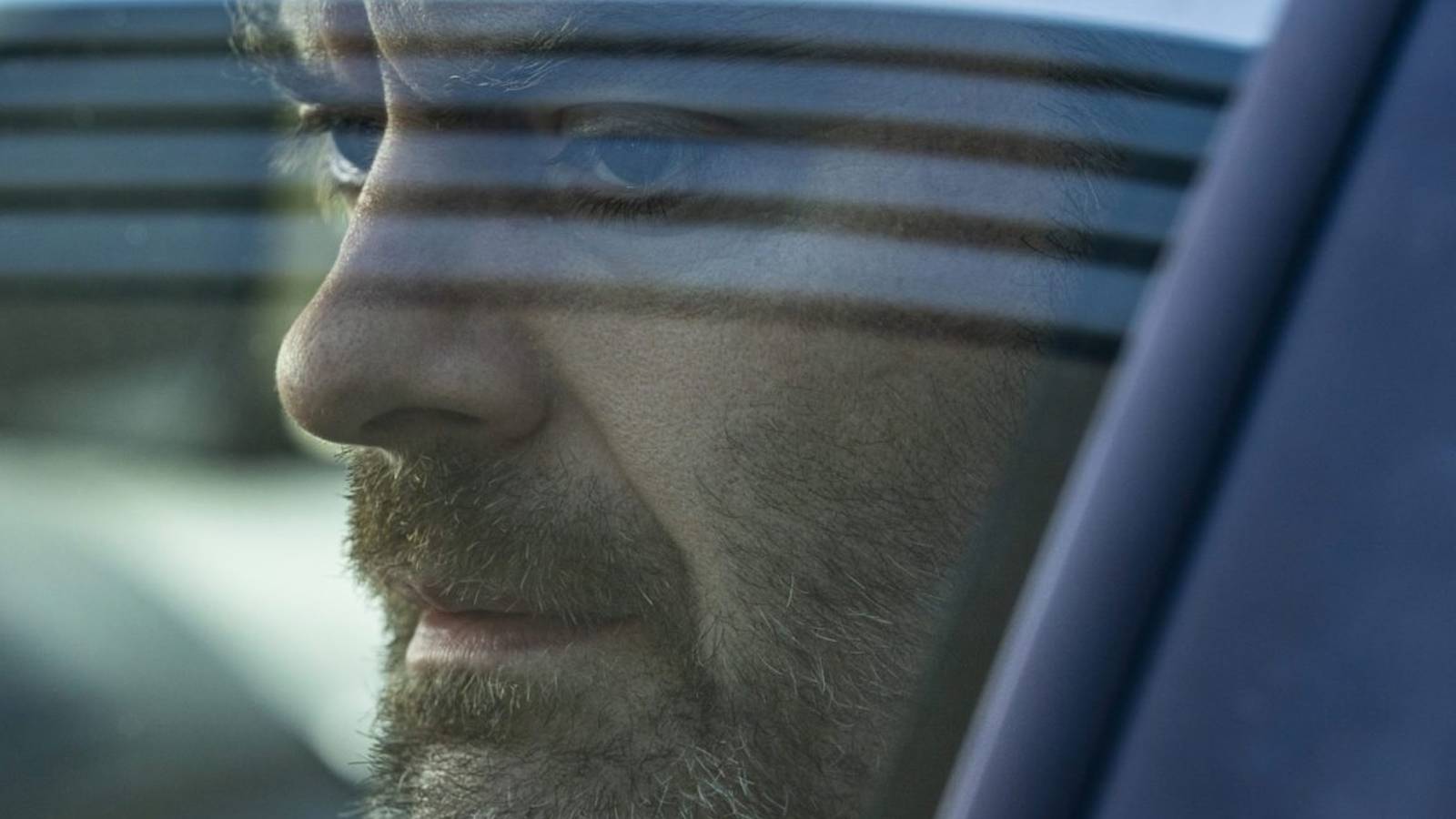 Bill Hader sits in a car in Barry