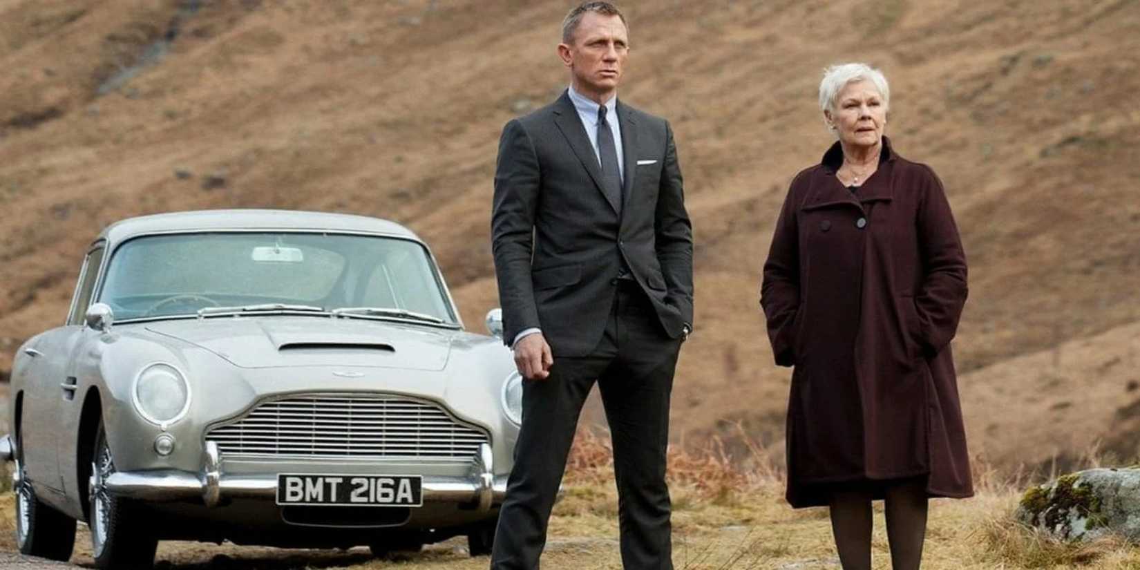 Daniel Craig and Judy Dench Bond and M next to Aston martin DB5