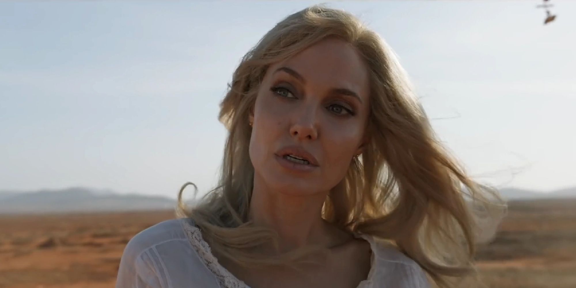 Thena staring unimpressed at something in the desert in Eternals