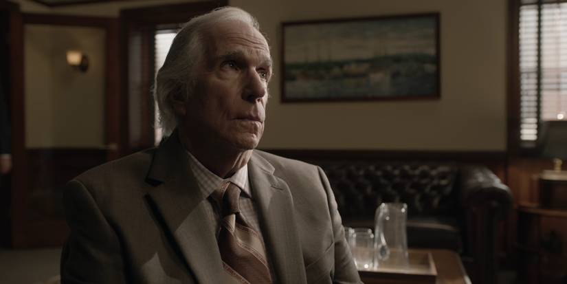 Gene sits on a TV set in Barry