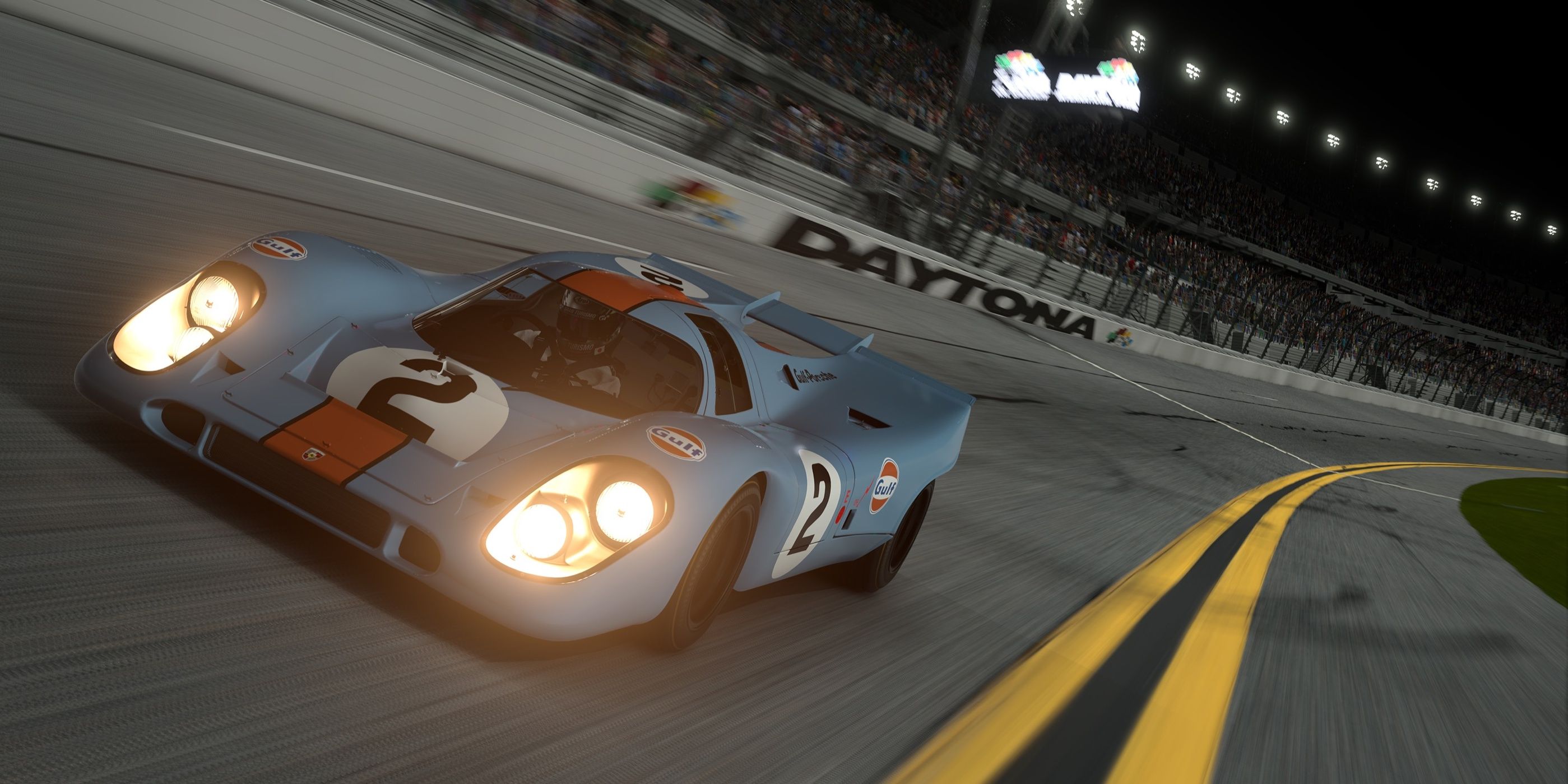 A race car driving the Daytona International Raceway at night in Gran Turismo 7