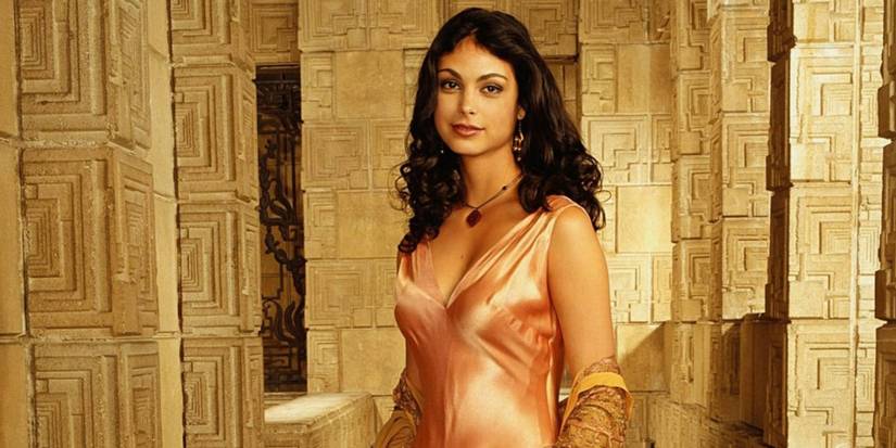 Inara Sera against a golden brick background in Firefly