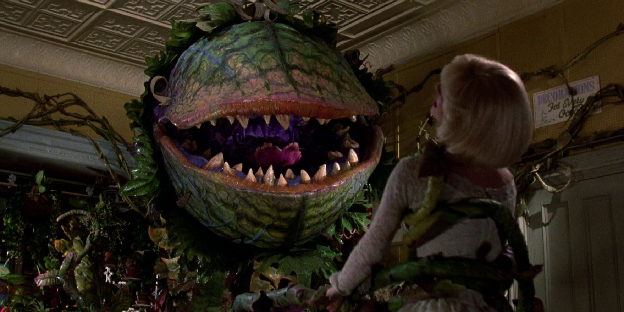 Audrey II grabbing Audrey with its vines in Little Shop of Horrors