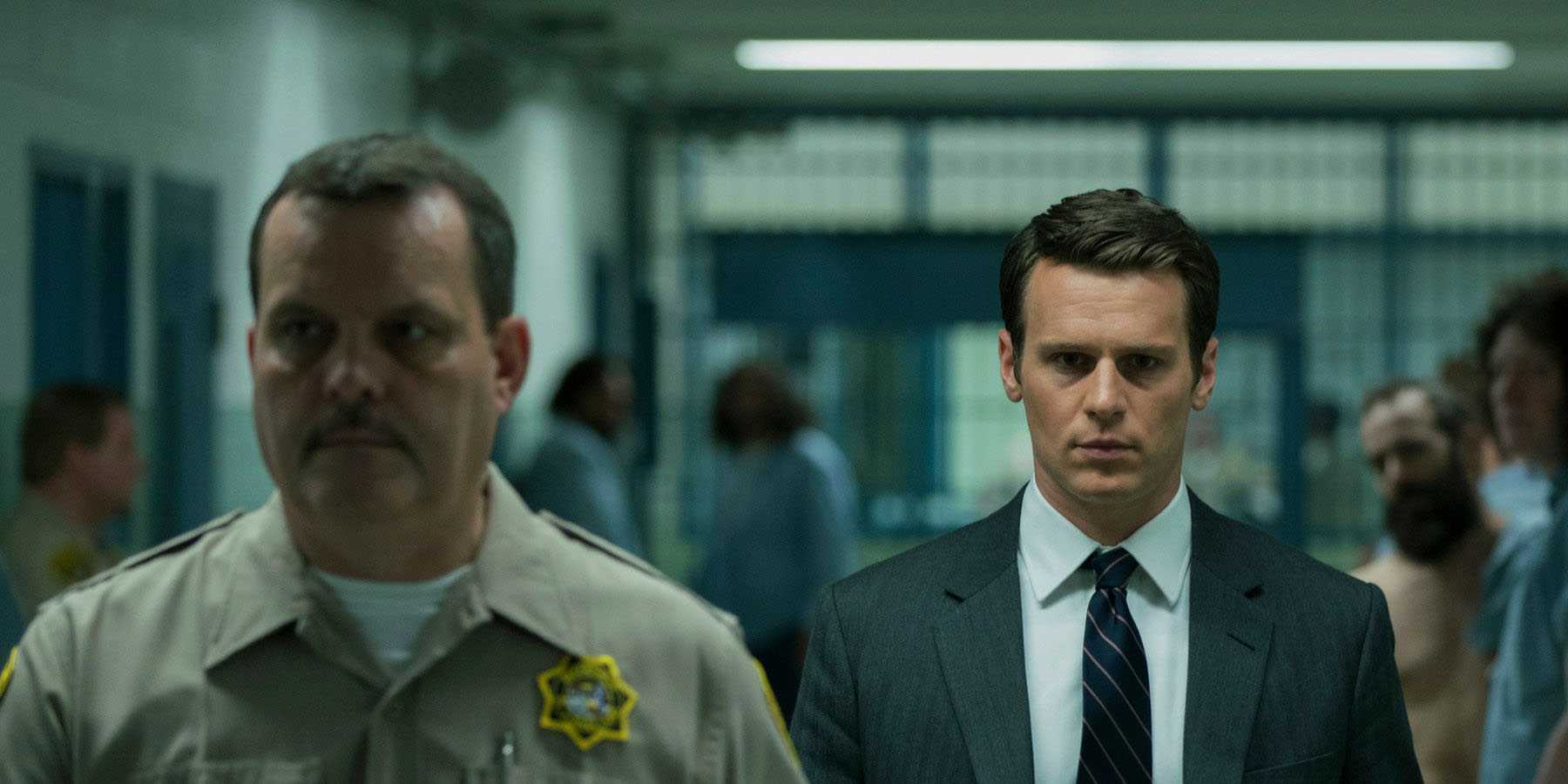 Holden Ford walking through a prison in Mindhunter