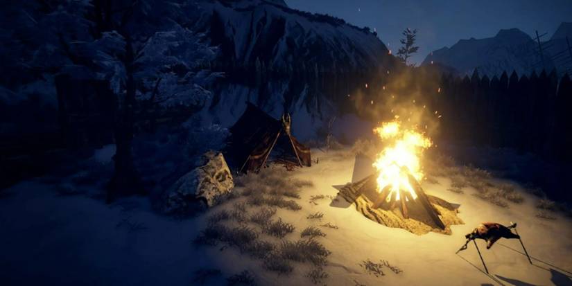 The player's camp in a snowy region, with a campfire in Outward