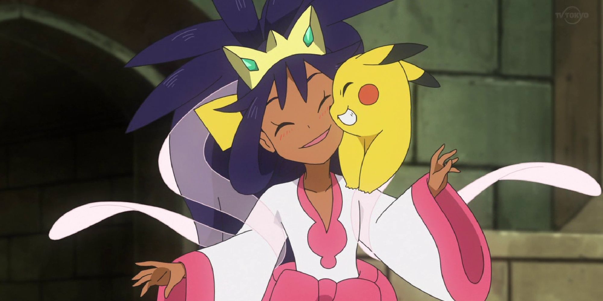 Iris in her Unova Champion outfit cuddling with Pikachu 