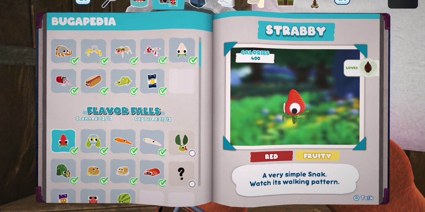 a notebook with a list of bugsnax on the left page and a strawberry with googly eyes and little, leaf legs on the right page 