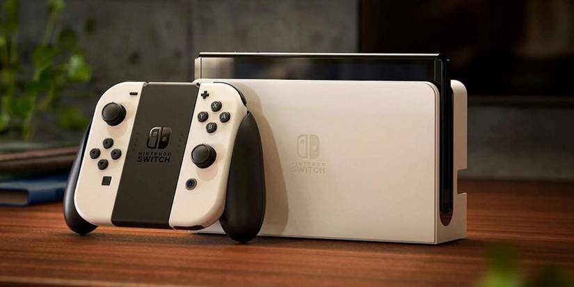 A white Nintendo Switch OLED with Joy-Cons removed sitting on a table