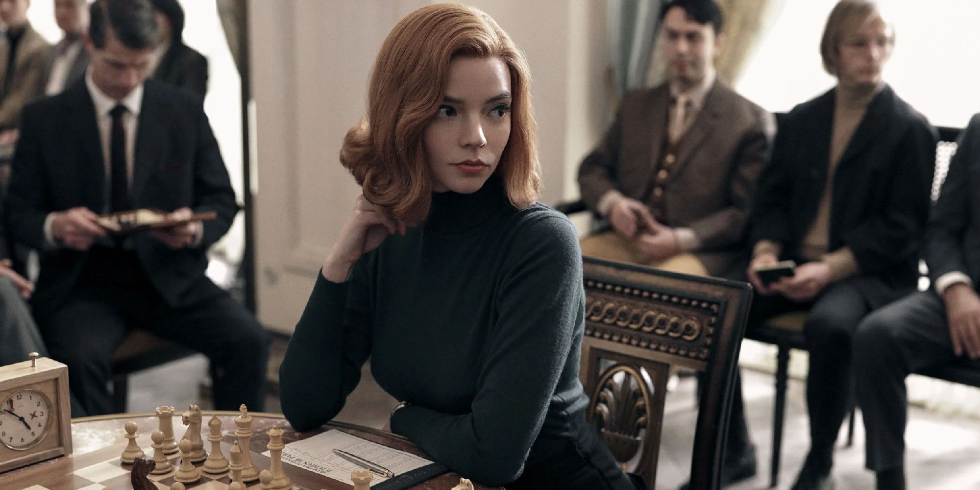 Anya Taylor-Joy as Beth Harmon sitting at a chess match in The Queen's Gambit.