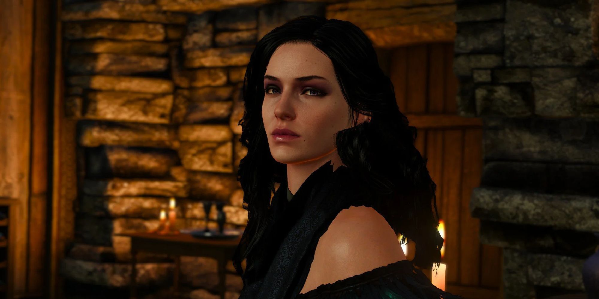 Yennefer in a darkly-lit stone cabin facing the screen