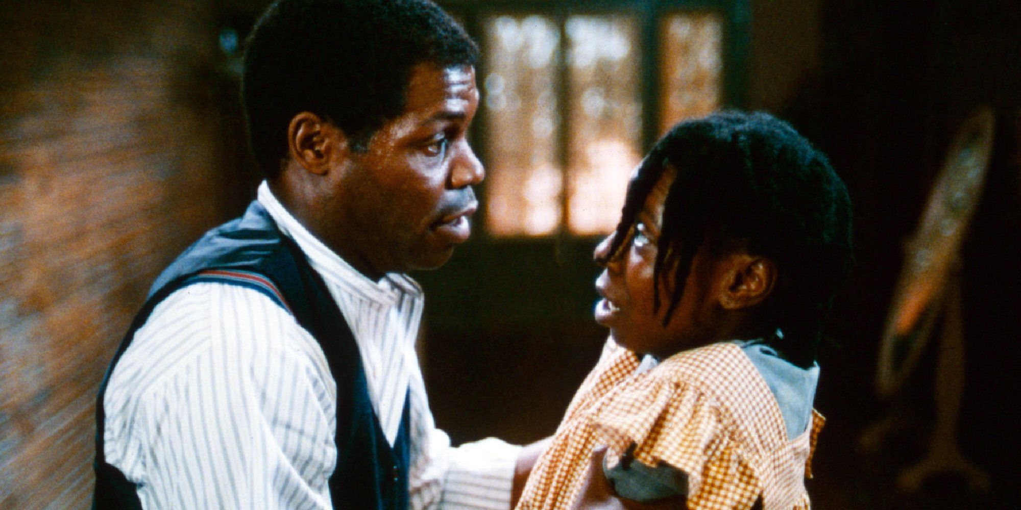 Willard Pugh holding onto Whoopi Goldberg's shoulders in The Color Purple