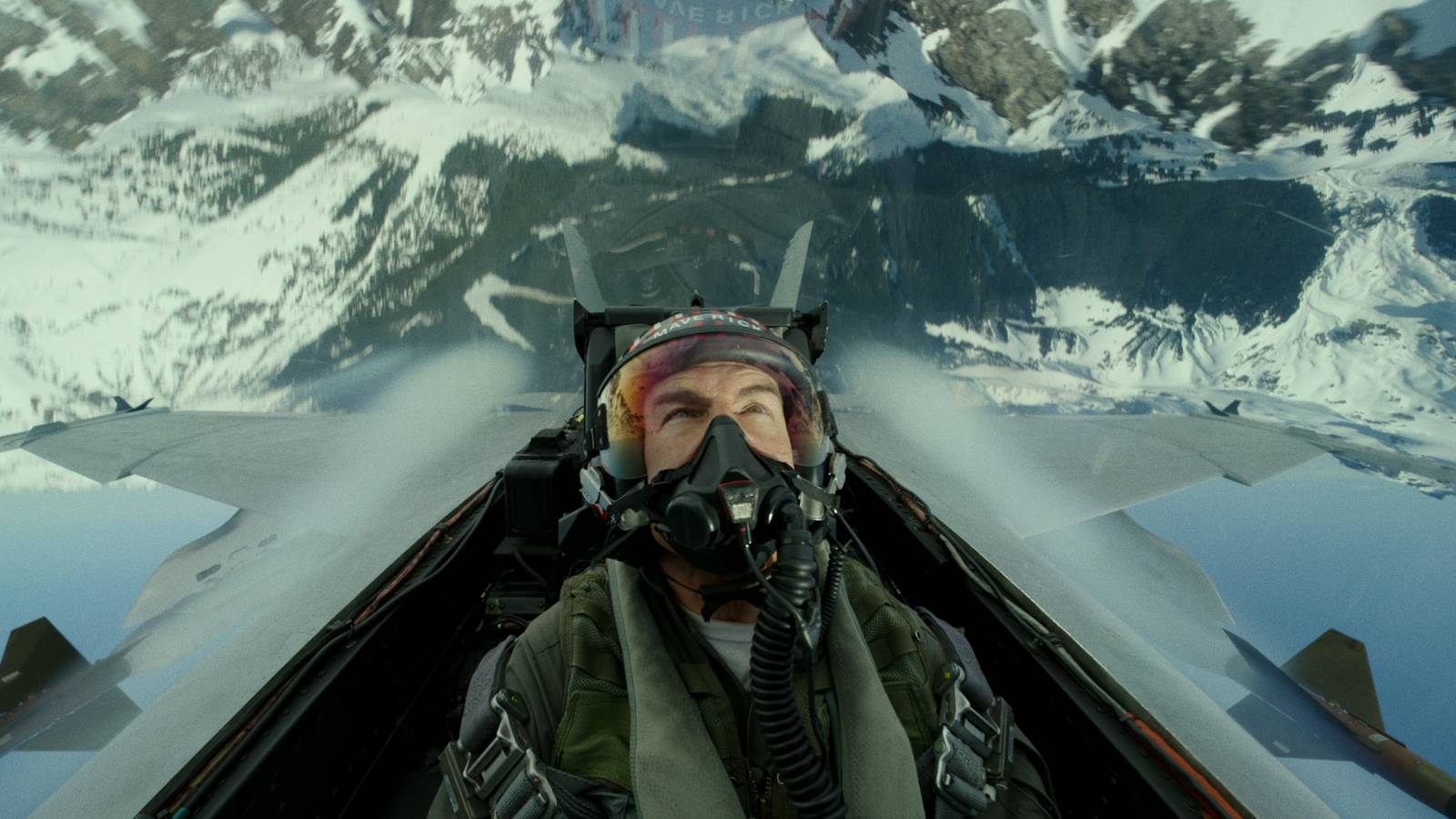 Tom Cruise flies over a mountain in Top Gun Maverick