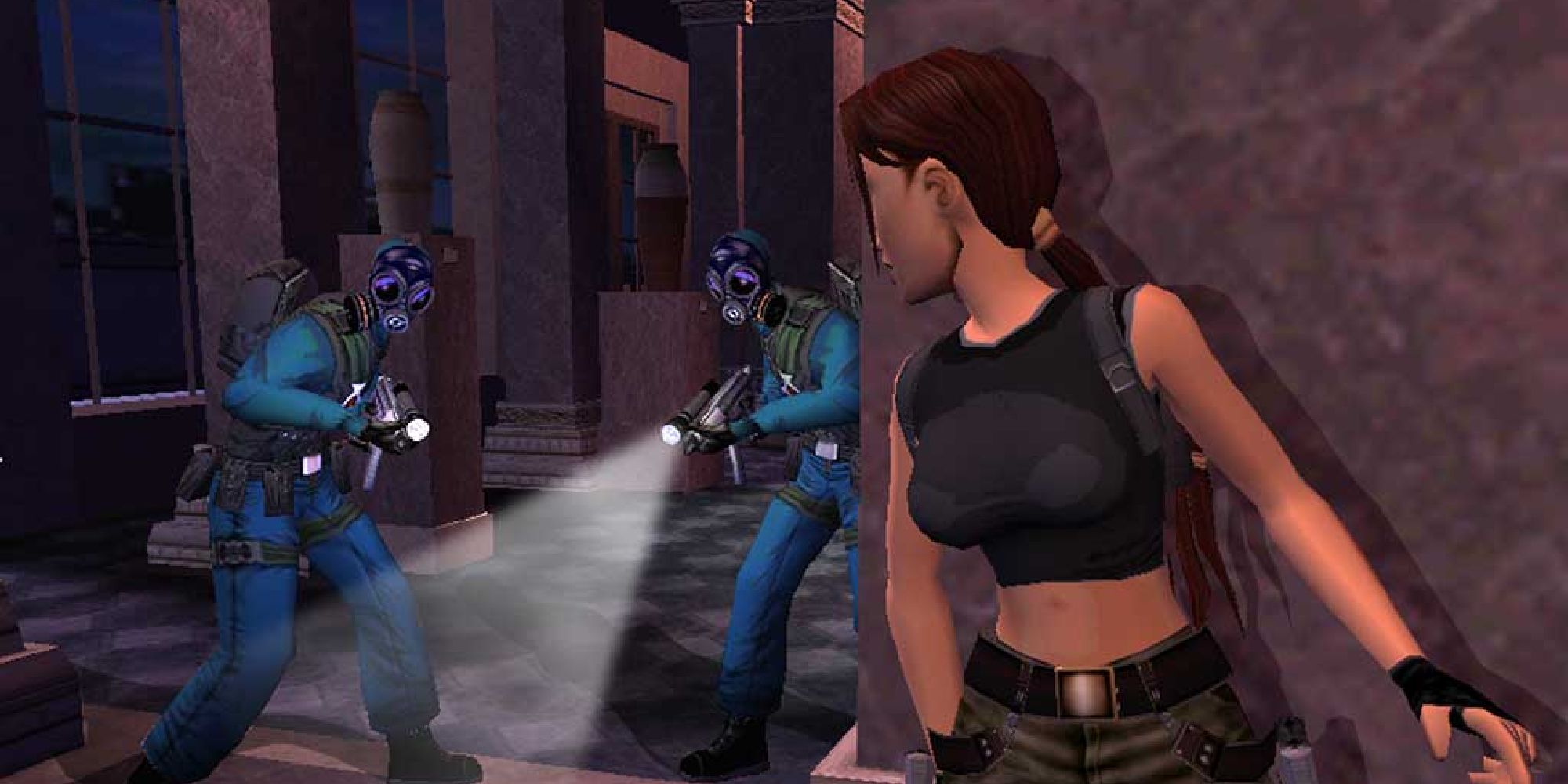 Lara sneaking past two soldiers in ski-masks in Angel of Darkness