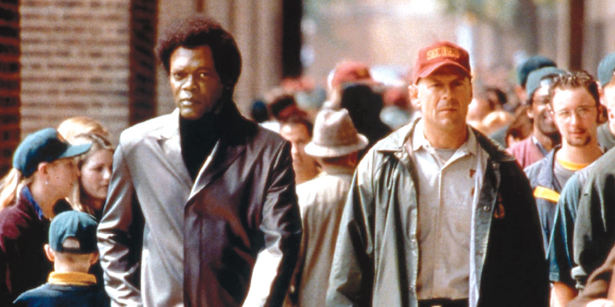 Bruce Willis and Samuel L. Jackson walking down a crowded street in Unbreakable