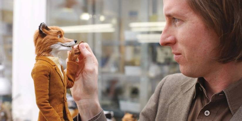 Wes Anderson fiddling with a Mr Fox figurine