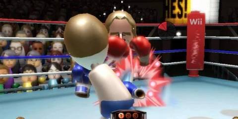 Two Miis boxing in Wii Sports surrounded by an audience of Miis