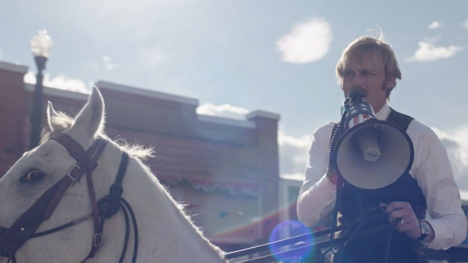 Dan Lafferty (Wyatt Russell) in parade for Sheriff in Under the Banner of Heaven