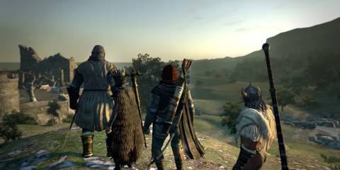 dragon's dogma Dark Arisen party looking over a cliff with a building in the background 