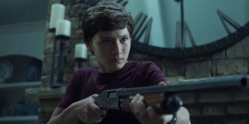 Jonah holding shotgun in Ozark