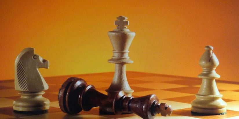 Resigned king surrounded by white pieces