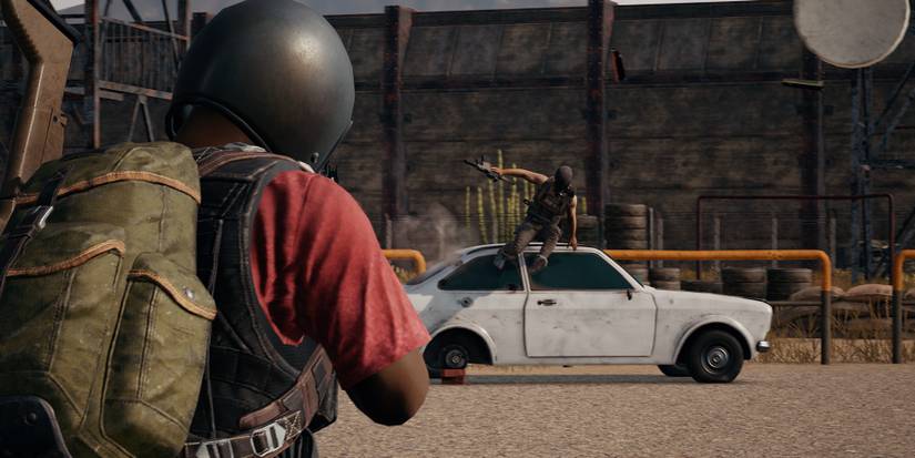 pubg player shooting at another player jumping over a car 