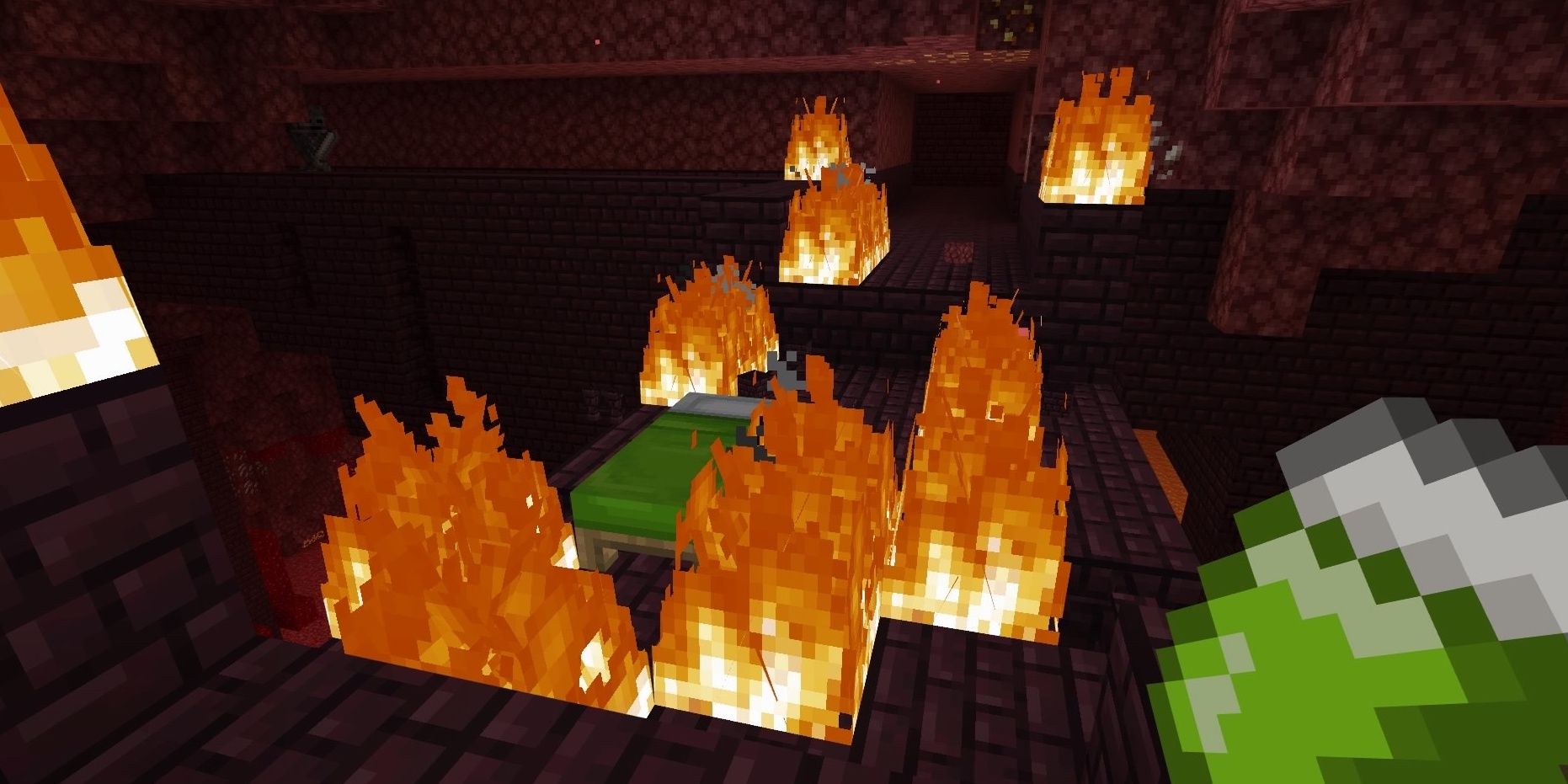 A green bed surrounded by fire in the Nether in Minecraft