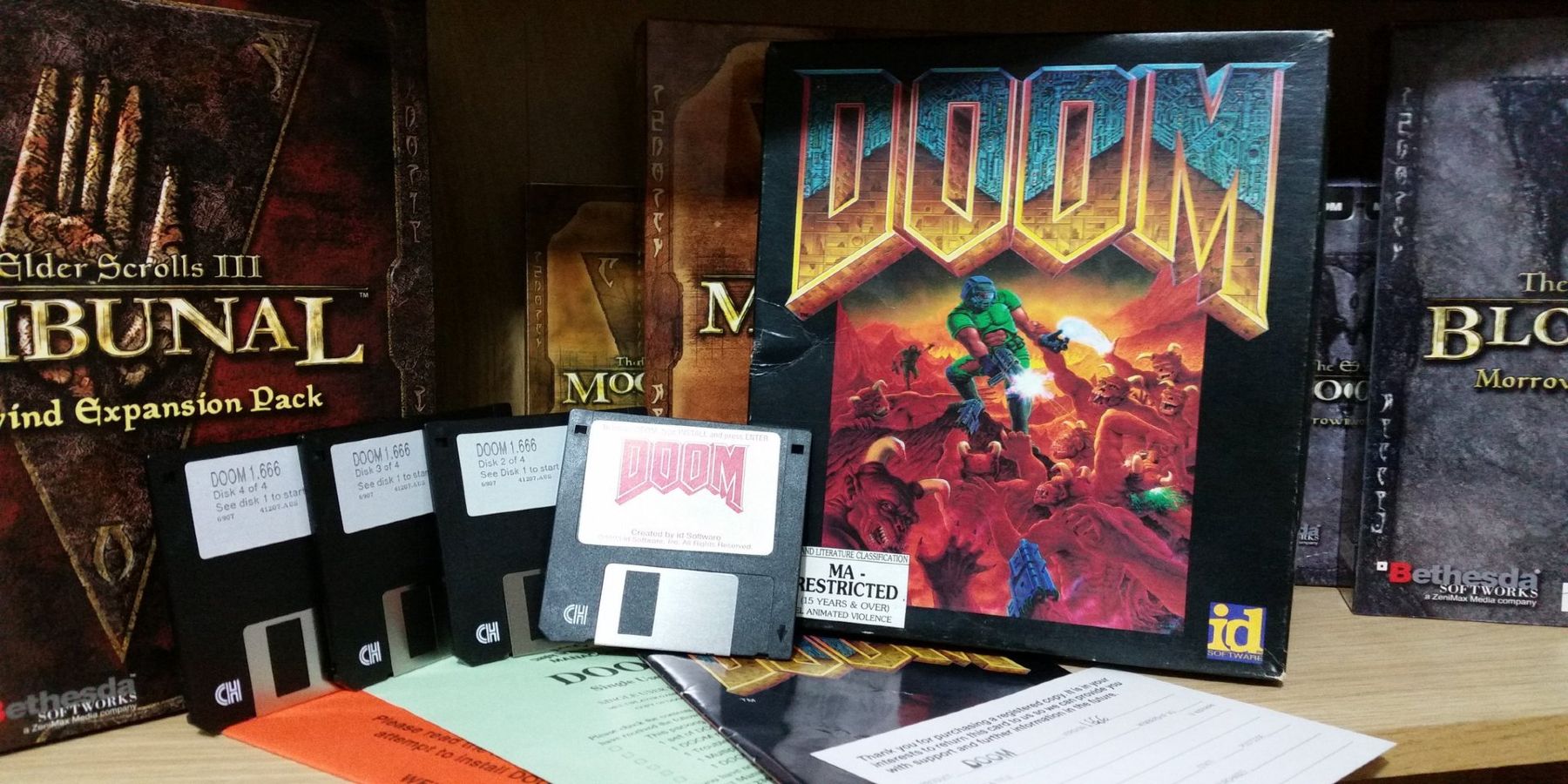 A collection of original Doom floppy disks and game packaging on display