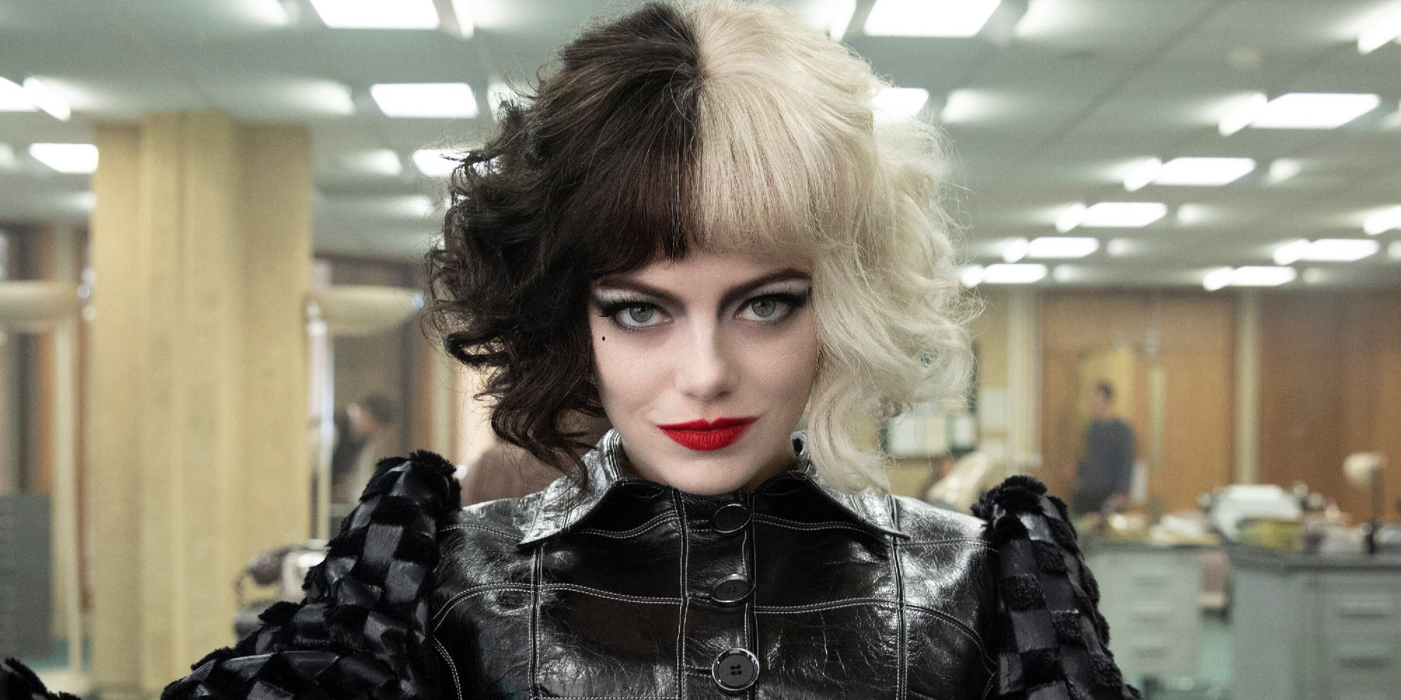 Emma Stone as Cruella de Vil in an office in 2021's Cruella