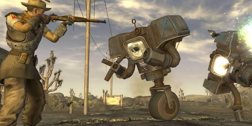 A man getting attacked by a robot while he shoots another in Fallout New Vegas