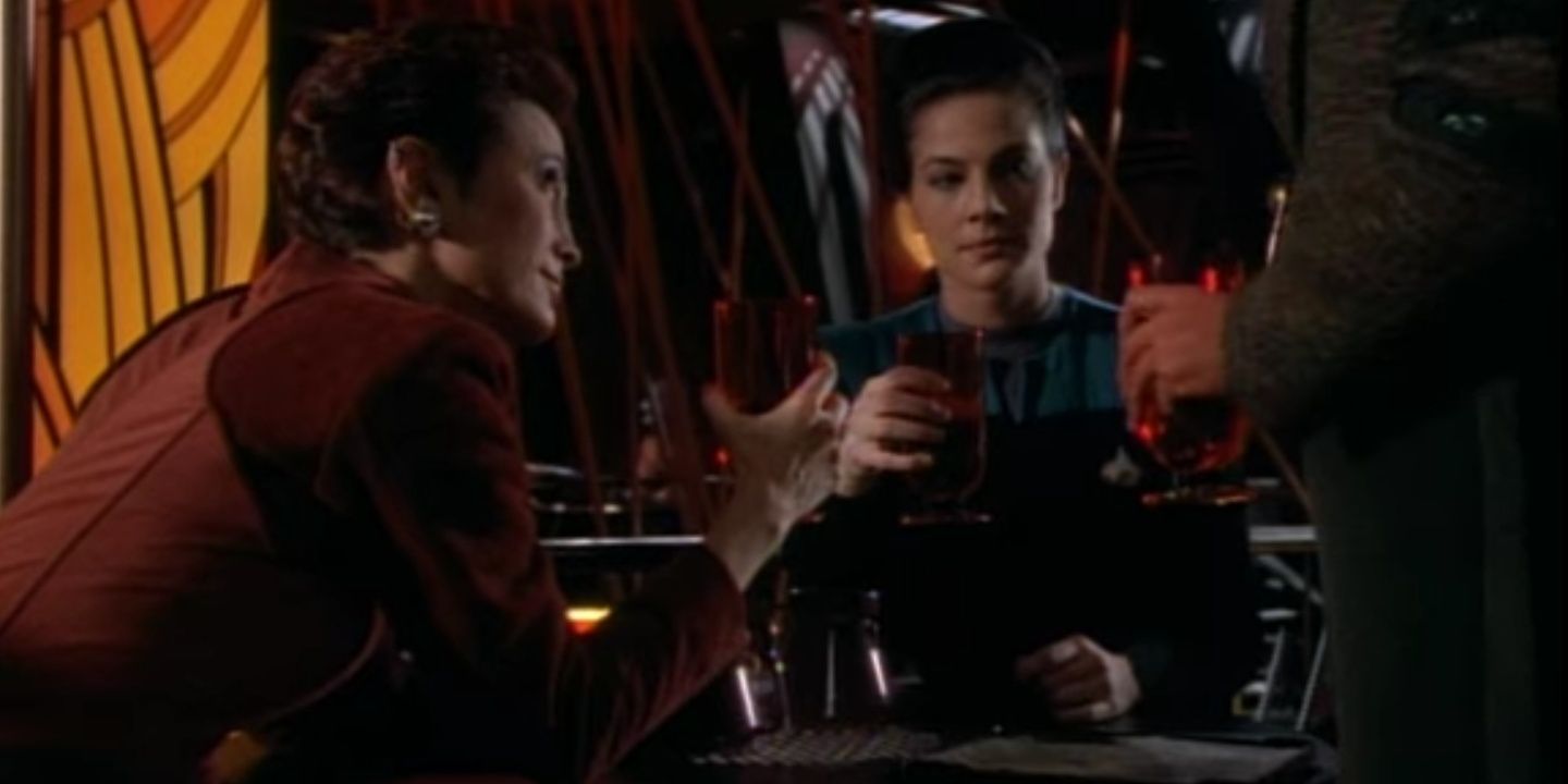 Kira (Nana Visitor) (left) and Dax (Terry Farrell) (right) toast their crewmates with Quark (Armin Shimerman) (right), who is slightly out of frame. Image source: Terrence Smith.