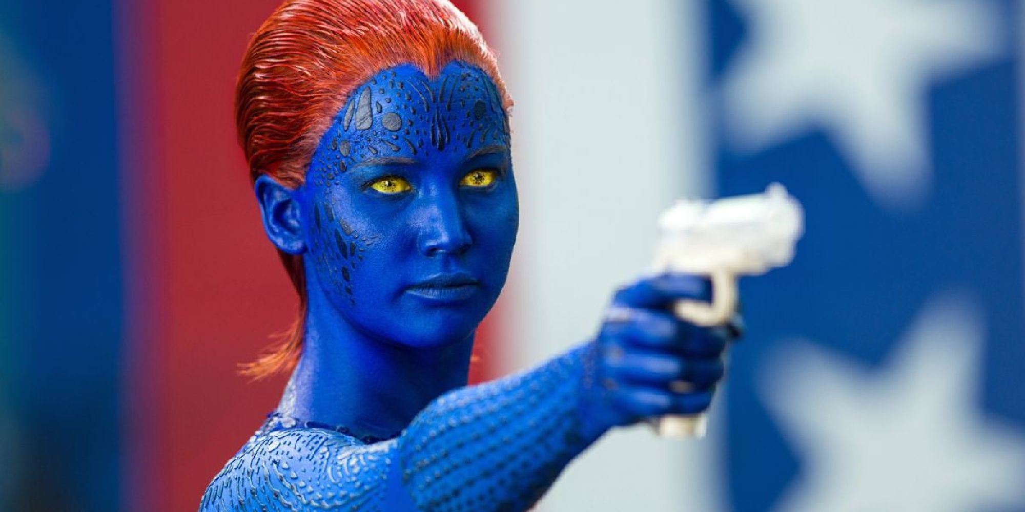 Jennifer Lawrence as Mystique holding a white gun in front of the American flag in Days of Future Past