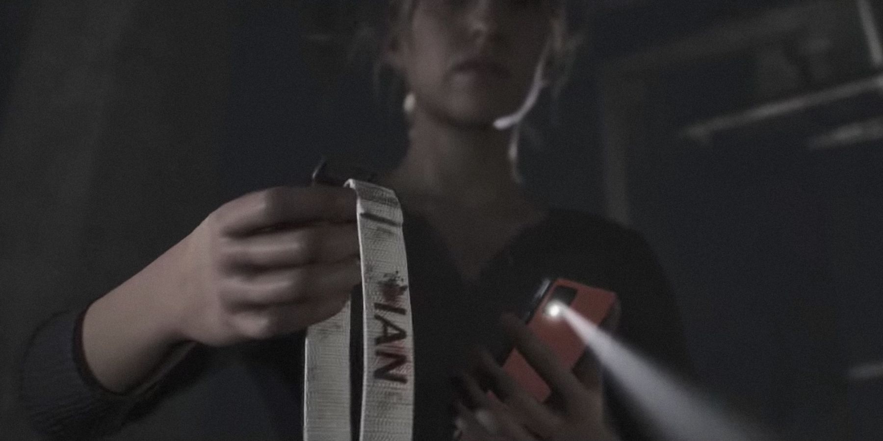 Laura holding a bloodied collar in the quarry