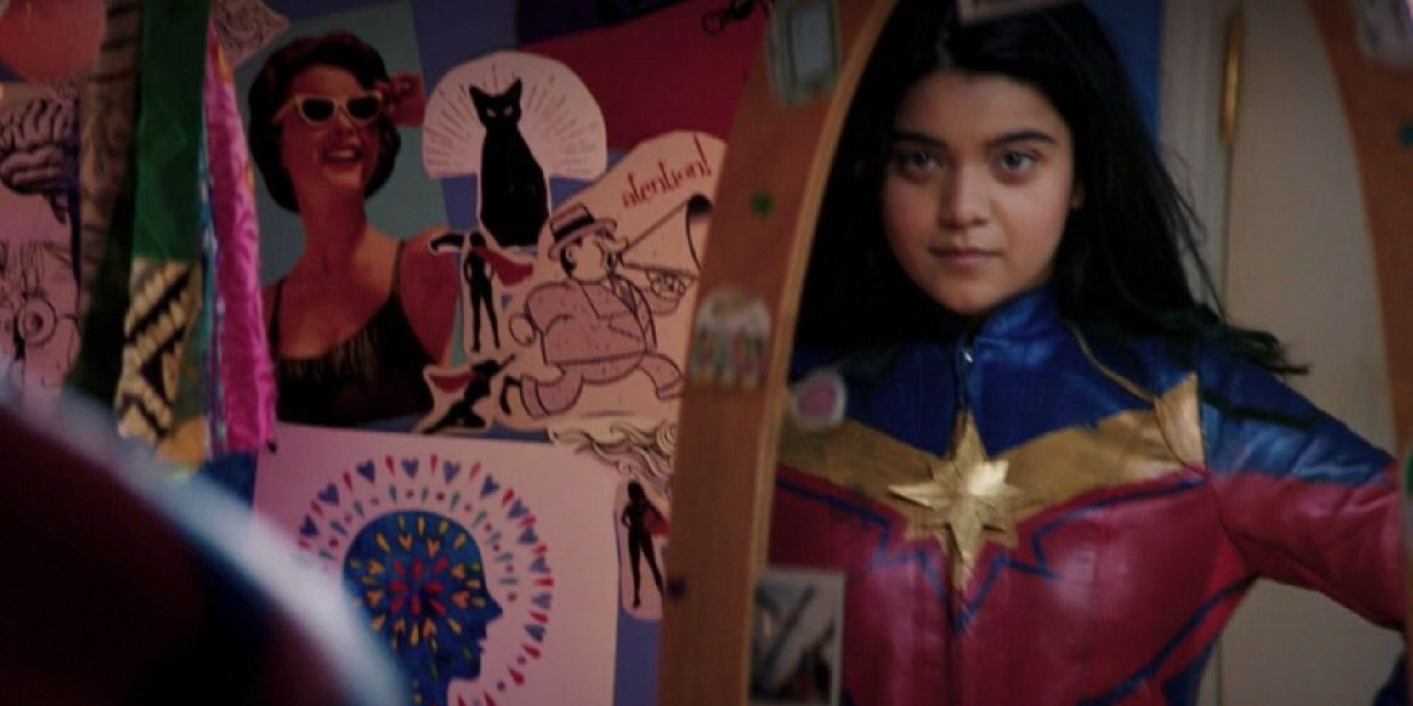 Kamala wearing her Captain Marvel cosplay looking in the mirror in Ms. Marvel