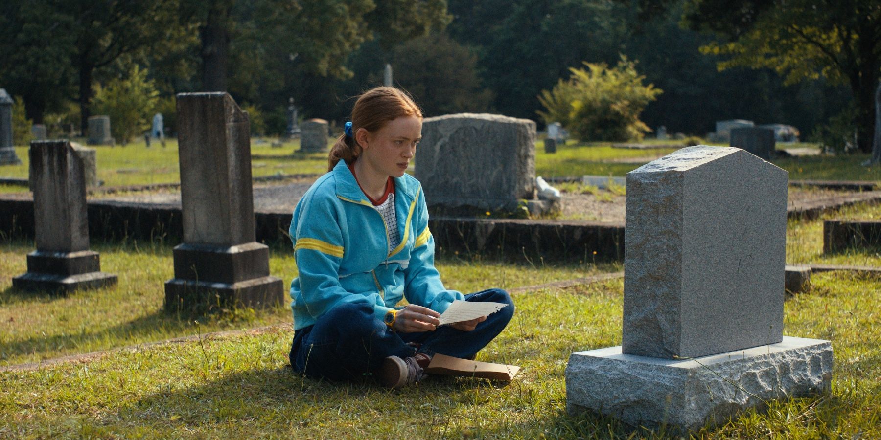 Max-Mayfield-Reads-Letter-In-Front-Of-Billy's-Grave