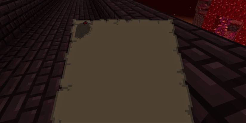 Looking down at a map in Minecraft where only the corner has been discovered