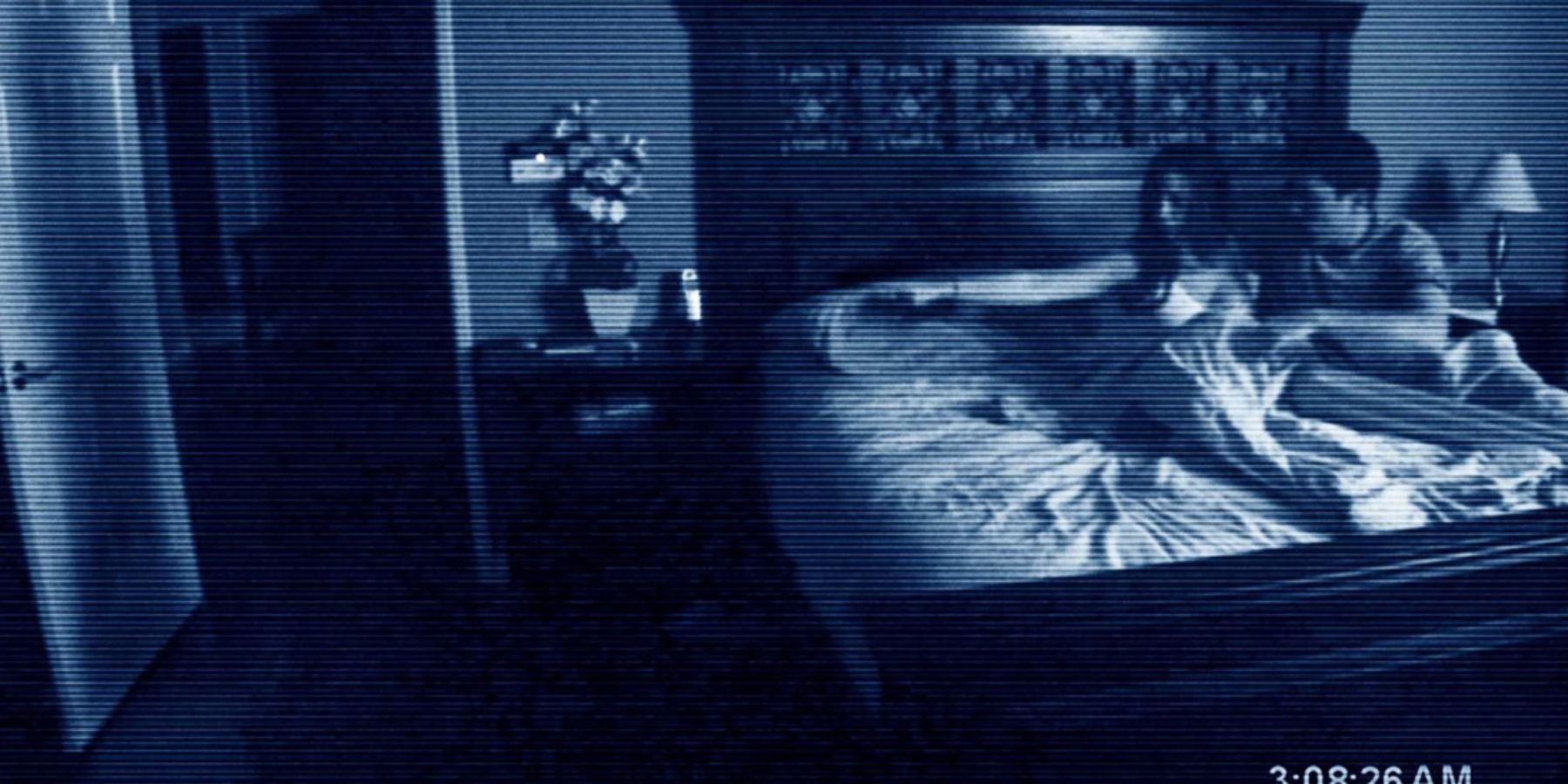 Katie and Micah scared in bed in Paranormal Activity (2007)