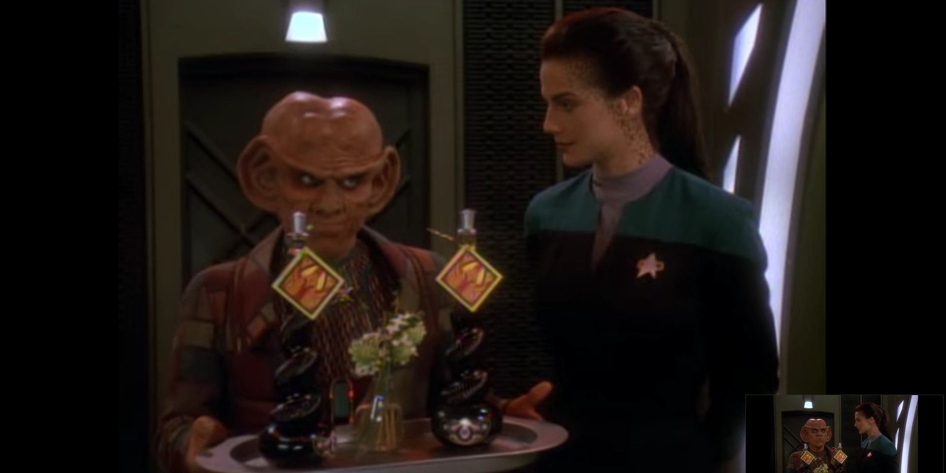 Quark (Armin Shimerman) (left) bears a tray with two bottles of Cardassian Kanar next to Dax (Armin Shimerman) (right). Image source: Terrence Smith
