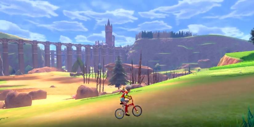 The player rides their bike in the open world of Sword and Shield