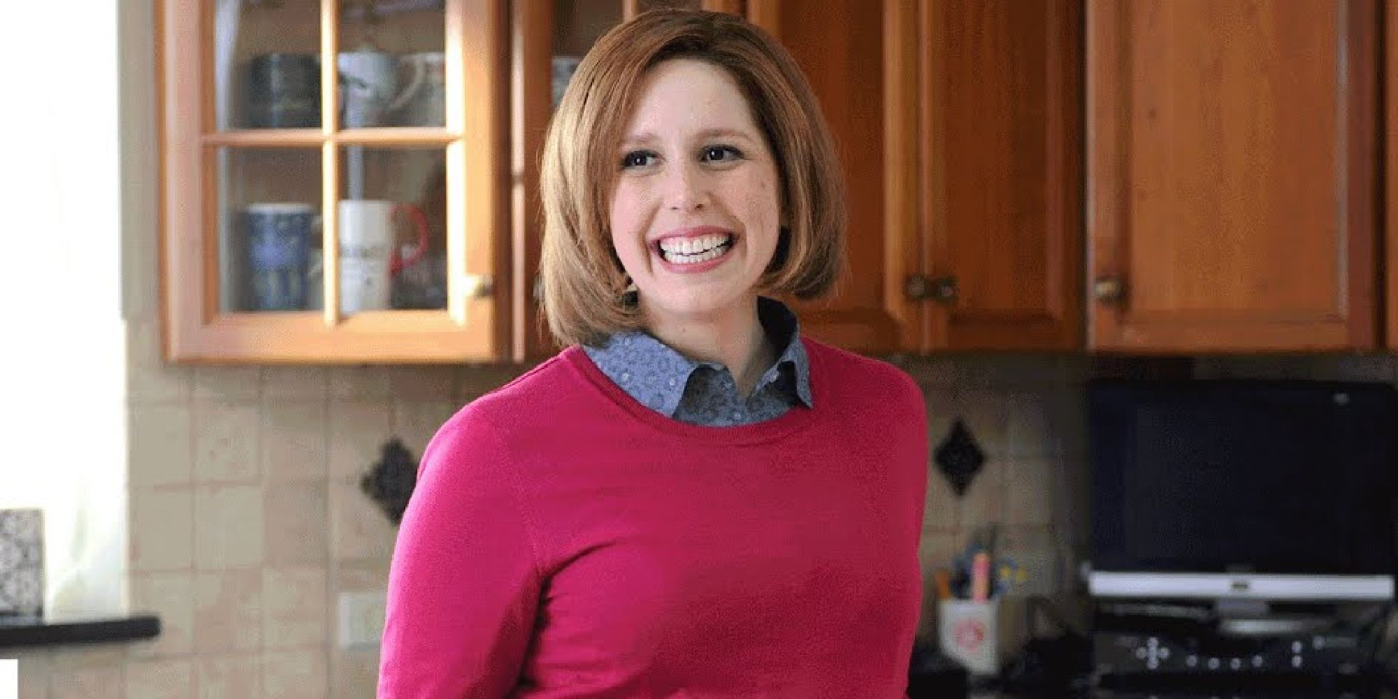 Vanessa Bayer smiling in a Totinos sketch on SNL