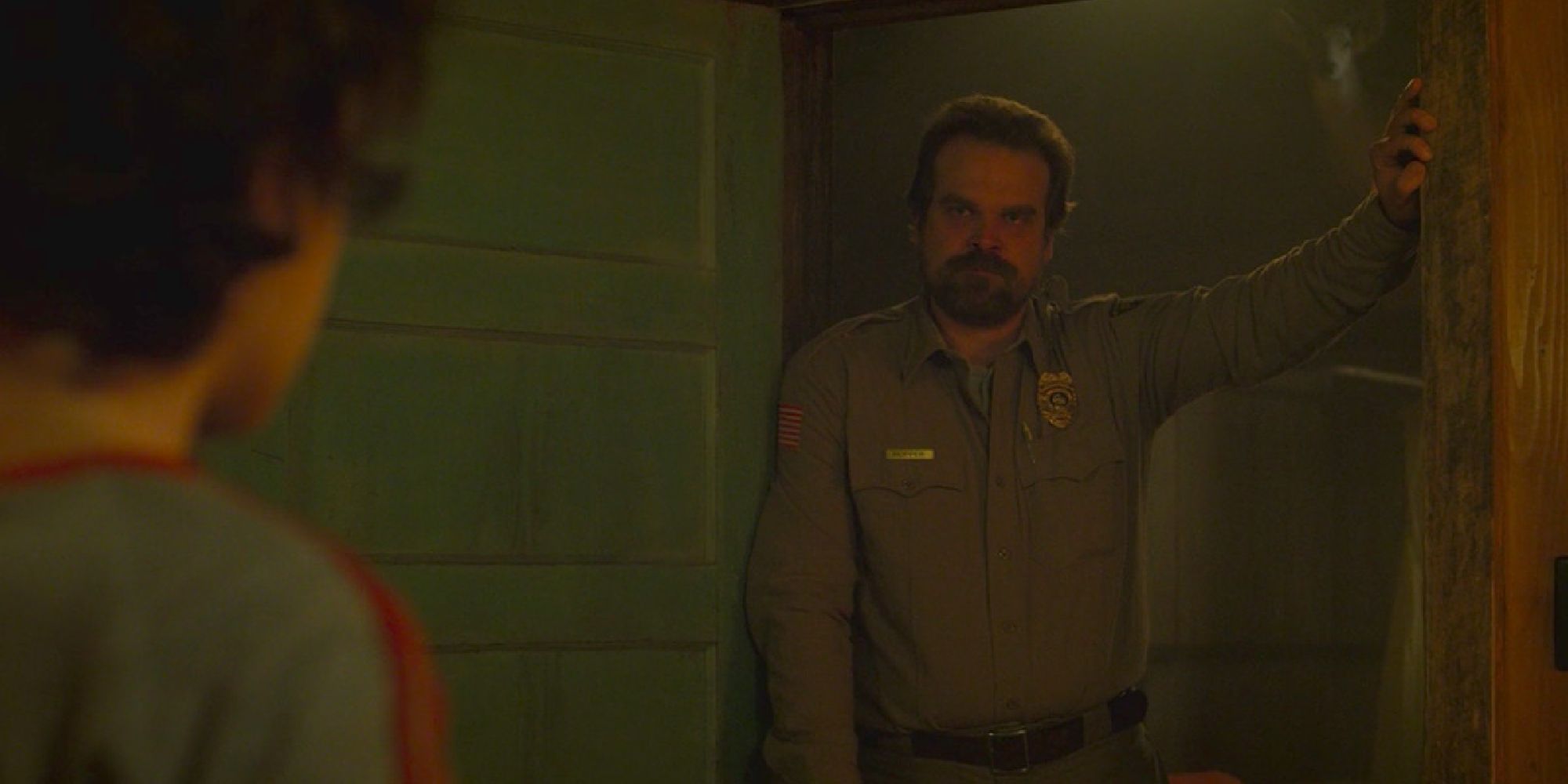 Hopper standing in Eleven's doorway in season 2