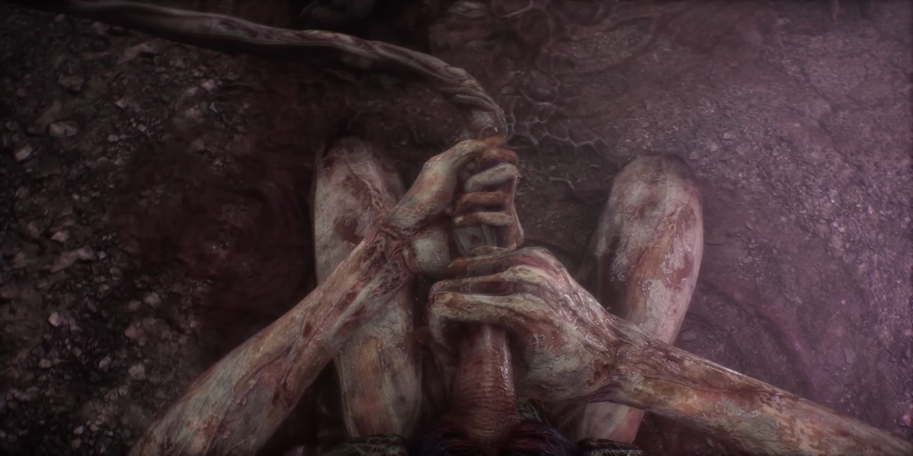 Scorn trailer footage showing the player removing an umbilical cord-like appendage from their abdomen.