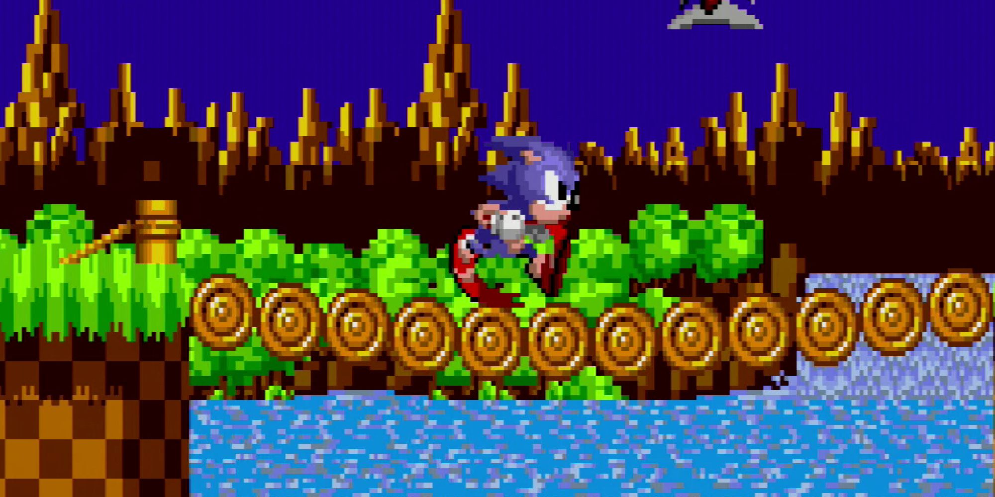 Sonic running over a log bridge in Green Hill Zone in Sonic the Hedgehog